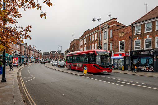 Twickenham, UK. 2 December 2023. Buses on Twickenham King Street with shops and people.