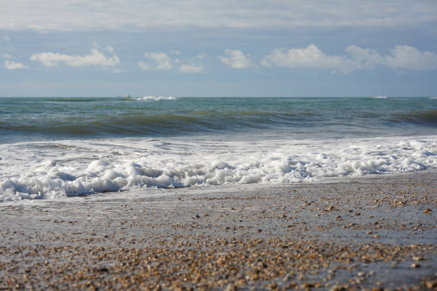 istock Wave is running into the beach and crashing the beach creating seafoam 1830226708