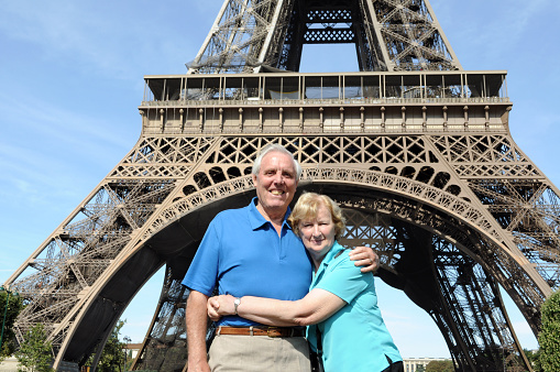 Senior couple enjoying their vacation in front of Eiffel Tower in Paris.Here is a different version: