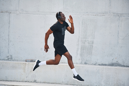 Sportive black man is running, morning routine.