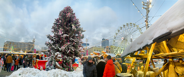 Katowice Poland - December 03, 2023 Christmas market in Katowice, Poland, adorned with a festive Christmas tree and numerous market stalls. A Christmas nativity scene adds to the holiday ambiance. People walking across the Christmas market