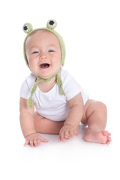 istock Cute Baby Wearing Knit or Crochet Frog Hat 183023846