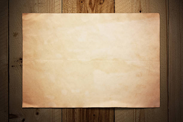 Old Blank Paper hanging on the Weathered Wooden Background closeup