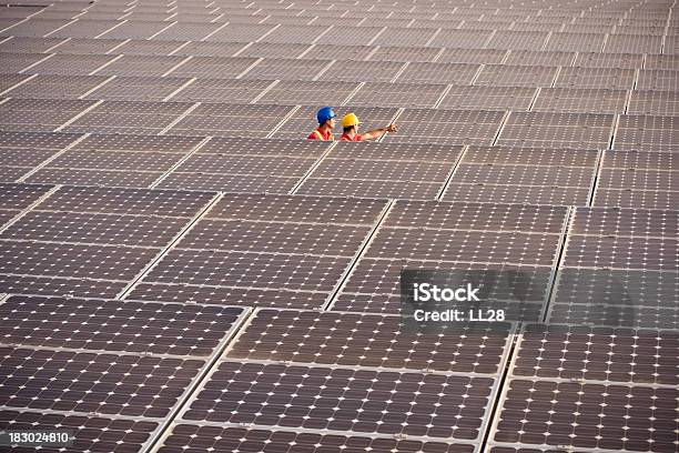 Two Engineers Working On Solar Panels Stock Photo - Download Image Now - Solar Power Station, Solar Energy, Construction Industry