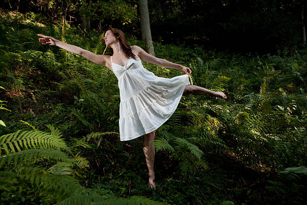 Ballerina in woods stock photo