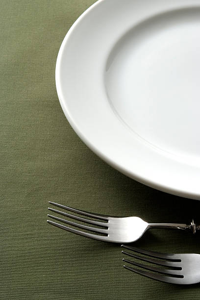istock Close-up of place setting on green tablecloth 183025283