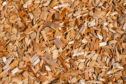 Wood chips close-up. Background. Surface for playgrounds and gardens.