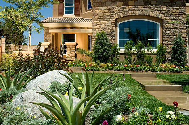 istock Contemporary brick home exterior with green garden 183025514