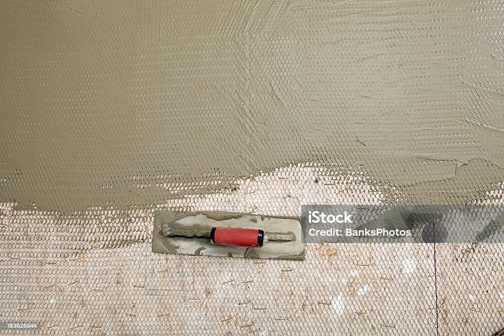 Trowel Resting on Bathroom Subfloor  Preparation Stock Photo