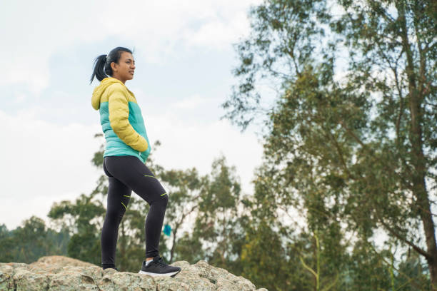 istock woman on mountain top looking at horizon 1830259610