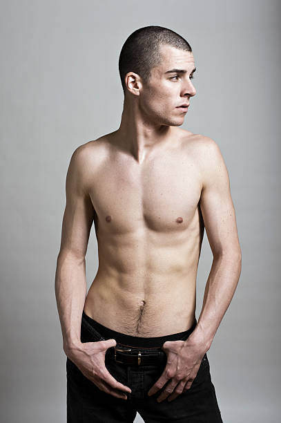 handsome shirtless young man posing - kaal geschoren hoofd stockfoto's en -beelden