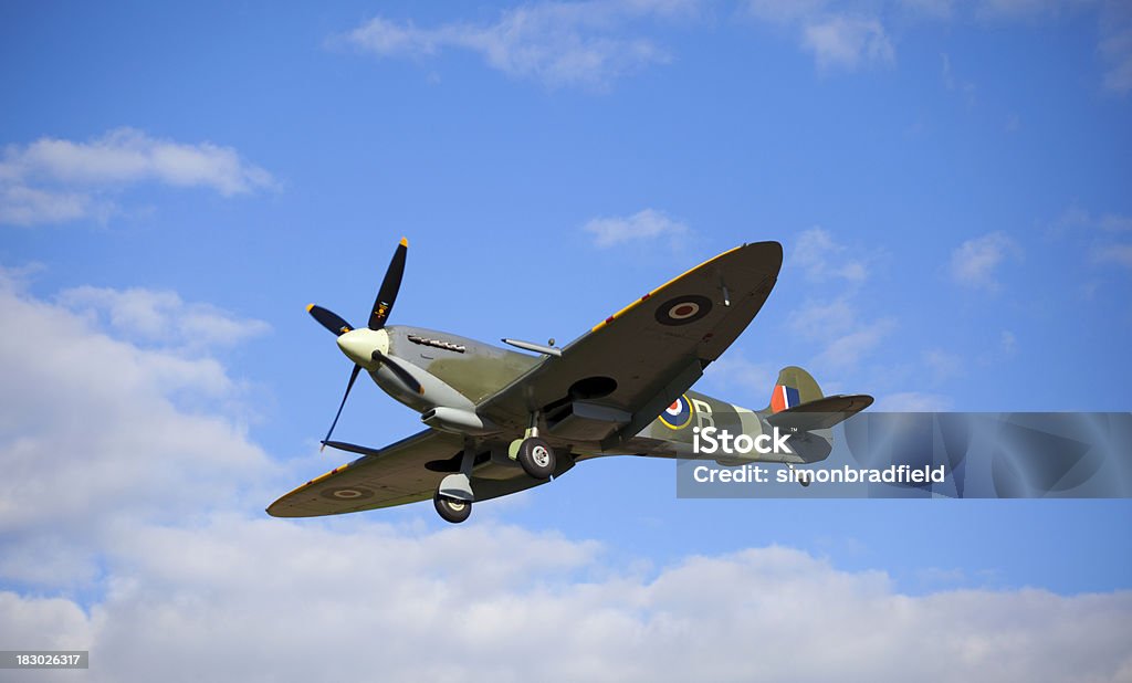 Spitfire "With its wheels down, a classic WW II Spitfire comes in to land." Fighter Plane Stock Photo