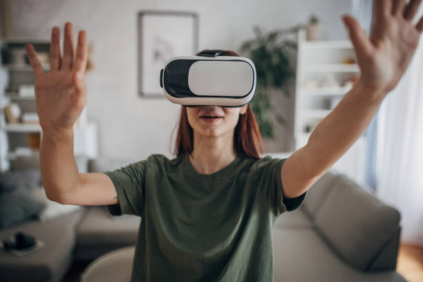 istock Woman having fun with VR headset 1830263836