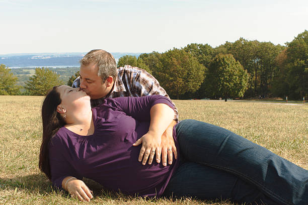 istock Pregnant Married Couple Kissing 183026415