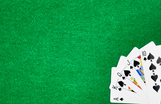 Royal Flush isolated on green poker felt.  Please see my portfolio for other gambling related images.