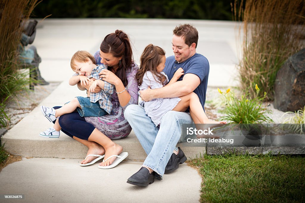 Heureux jeune famille Chatouiller et rire ensemble à l'extérieur - Photo de 2-3 ans libre de droits