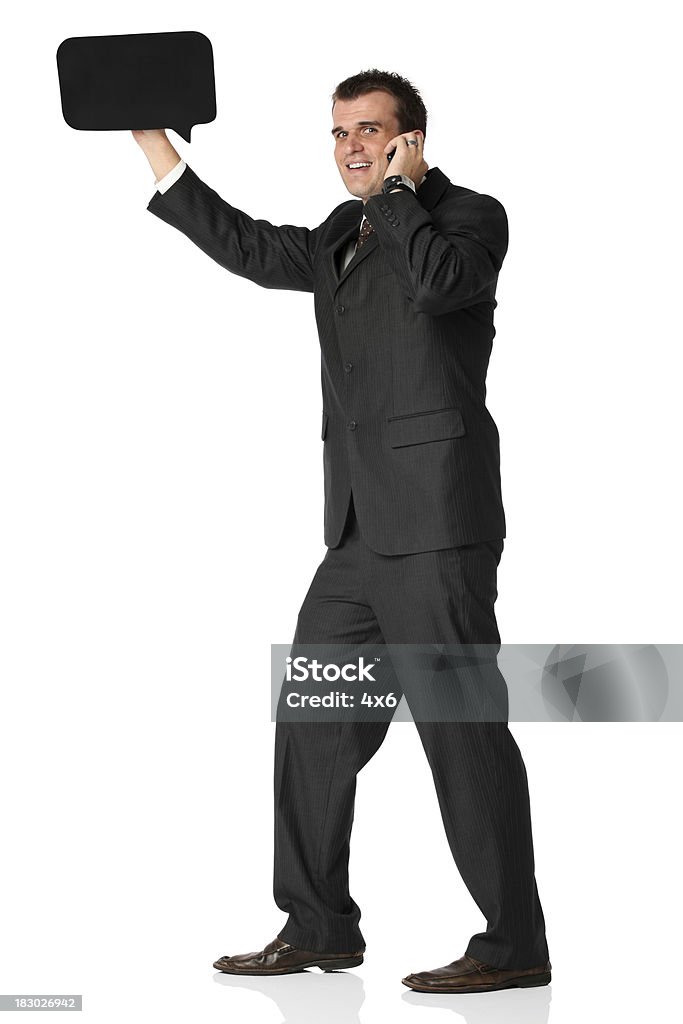 Businessman holding a speech bubble and talking Businessman holding a speech bubble and talkinghttp://www.twodozendesign.info/i/1.png Adult Stock Photo