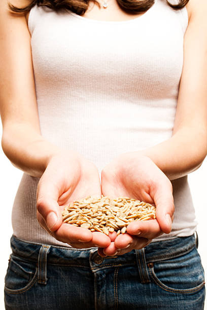 Young Woman Holding Sunflower Seeds in Her Palms stock photo