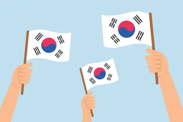 Vector illustration of People hands raising flags of South Korea. Vector illustration of South Korea flags in flat style.