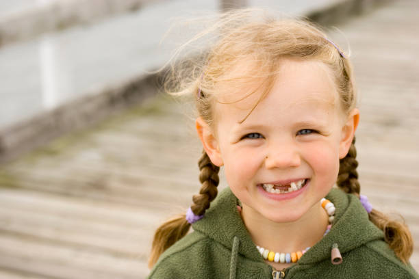 Girl with funny tooth gap stock photo