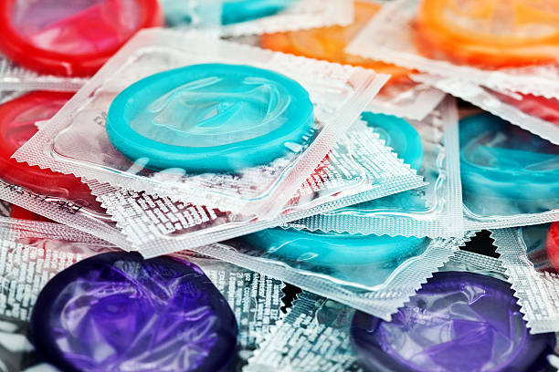 Safe Sex  Colorful Condoms Collection of colorful condomsSelective focus; shallow DOF contraceptive photos stock pictures, royalty-free photos & images