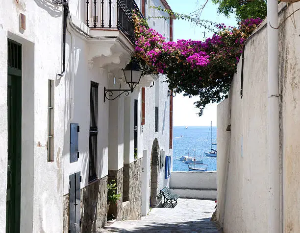 "View of the ocean by a narrow street in Cadaques in Catalonia,Spain."