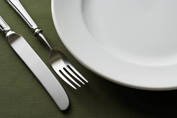 istock High angle view of place setting on green tablecloth 183028409