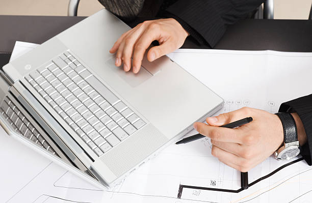 istock Working on the laptop and blueprints 183028493