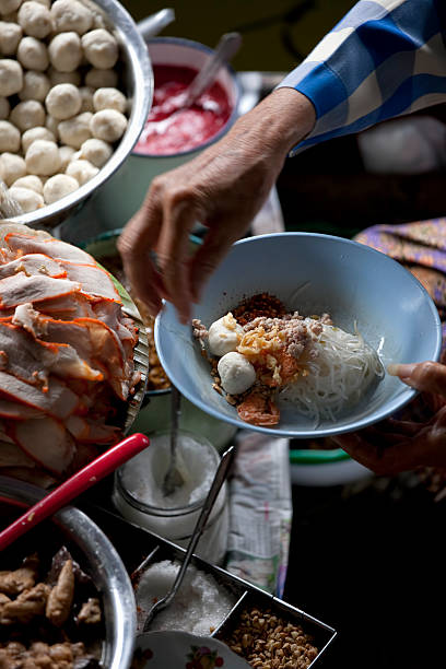 Preparation of Thai noodle soup, Thailand.
