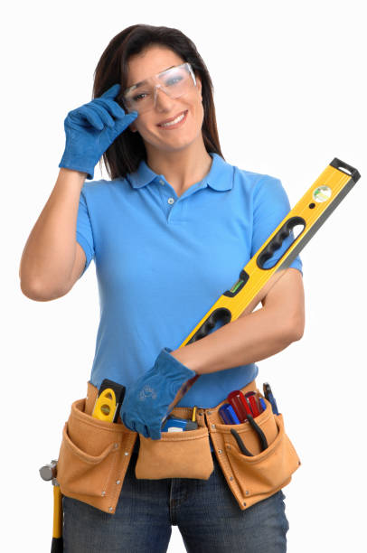 Handywoman Isolated on White Background with tools Handywoman Isolated on White Background with tools woman wearing tool belt stock pictures, royalty-free photos & images