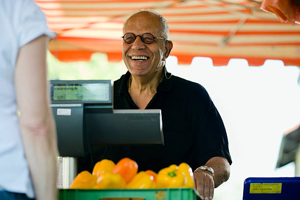 istock Man Checking Out at an Outdoor Market 183029653