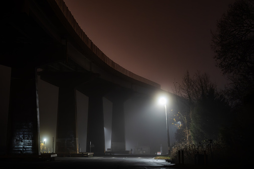 Solomons, Maryland, USA A night view of the parking lot under the Solomons Bridge over the Patuxent River in the fog.