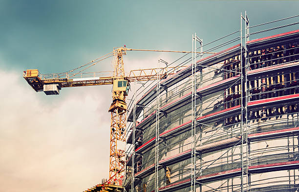 Crane at a construction site crane at a construction site construction skyscraper machine industry stock pictures, royalty-free photos & images