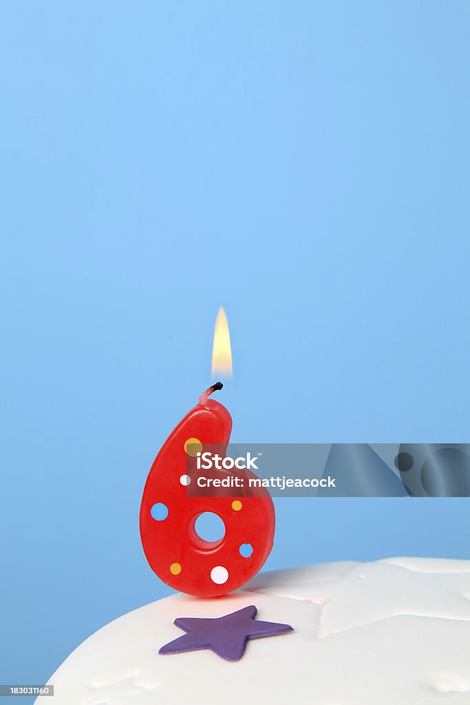 6th Birthday candle Red Birthday candles against blue background Anniversary Stock Photo