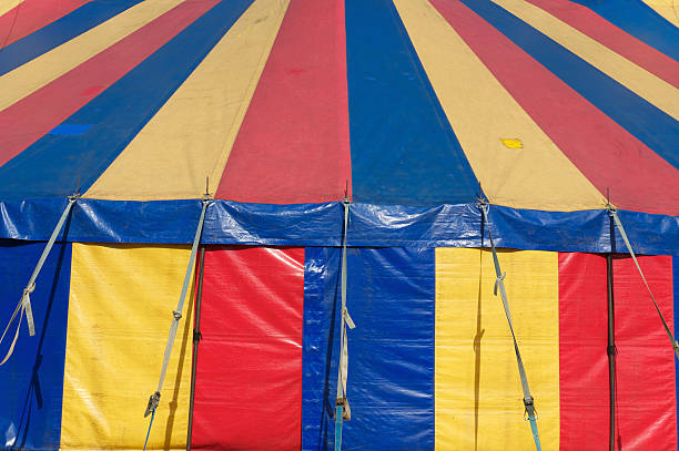 istock A red blue and yellow circus tent is worn in this close up. 183031247