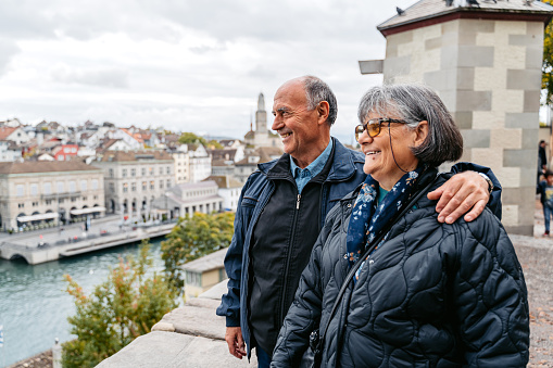 Senior couple enjoying the view of Limmat river in Zurich, Switzerland.