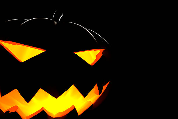 Backlighted Halloween Pumpkin on Black Background, Close-Up (XXXL) stock photo