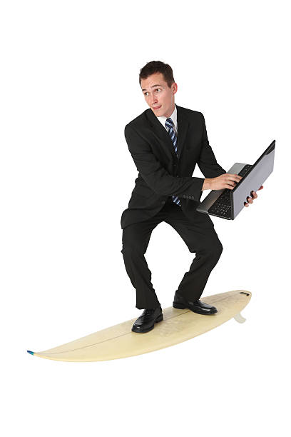 istock Businessman using laptop on a surfboard 183031460