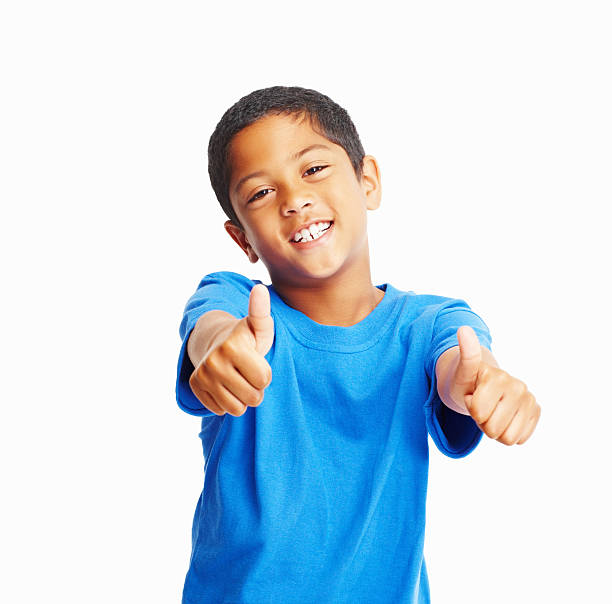 istock Cute boy gesturing thumbs up isolated against white background 183031684