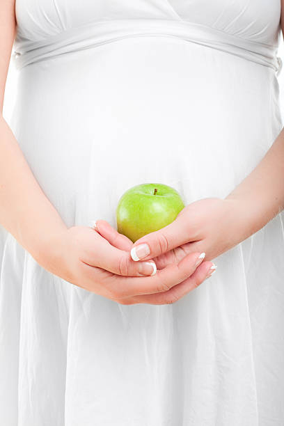 istock Pregnant woman holding a green apple 183032007