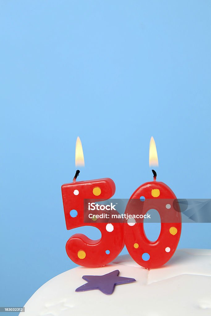 50th Birthday candles Red Birthday candles against blue background Number 50 Stock Photo