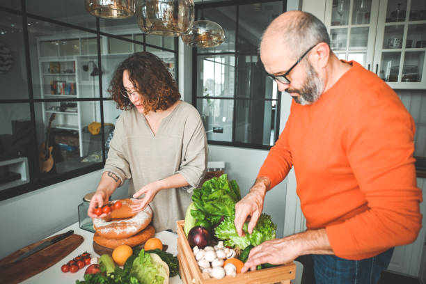 istock husband and wife cooking in the kitchen 1830326182
