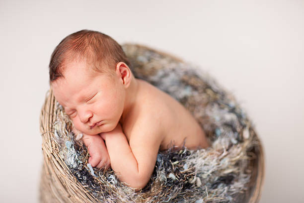 istock Newborn Baby Sleeping Peacefully in Basket with Fuzzy Texture 183032842