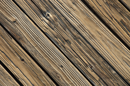 Jersey Shore Boardwalk boards background in early morning light. Shot looking straight down at boards on diagonal.