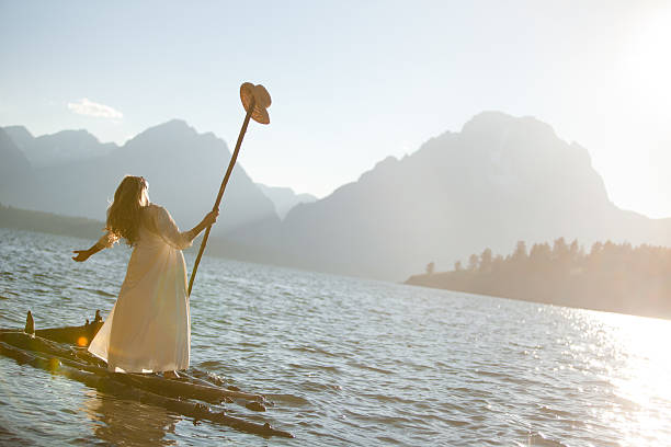 Beautiful woman on a wooden raft A beautiful woman on a wooden raft out in the middle of a lake in Wyoming.See More: spirituality adventure searching tranquil scene stock pictures, royalty-free photos & images