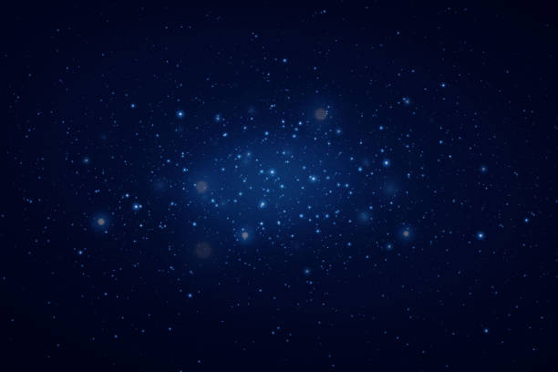 istock Realistic starry sky with blue glow of light. Bright stars with reflections in the dark sky. 1830334273