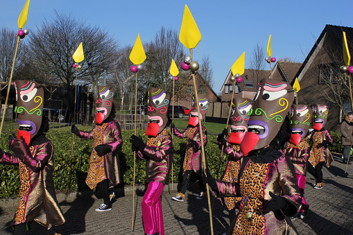 Hulst, Holland - feb 25, 2017: a beautiful group of people disguised as african bushmen with spears and masks in walking the carnival parade through the streets
