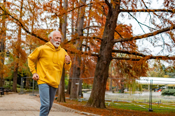 istock Senior man out for a run in the park 1830339811