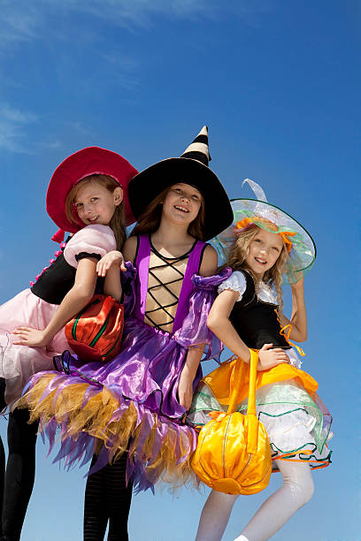 istock Three Cute Little Witches Standing with Bags. 183033985