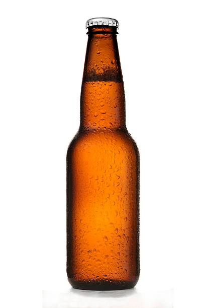 Beer Bottle A beer bottle on a white background with condensation. beer bottle photos stock pictures, royalty-free photos & images